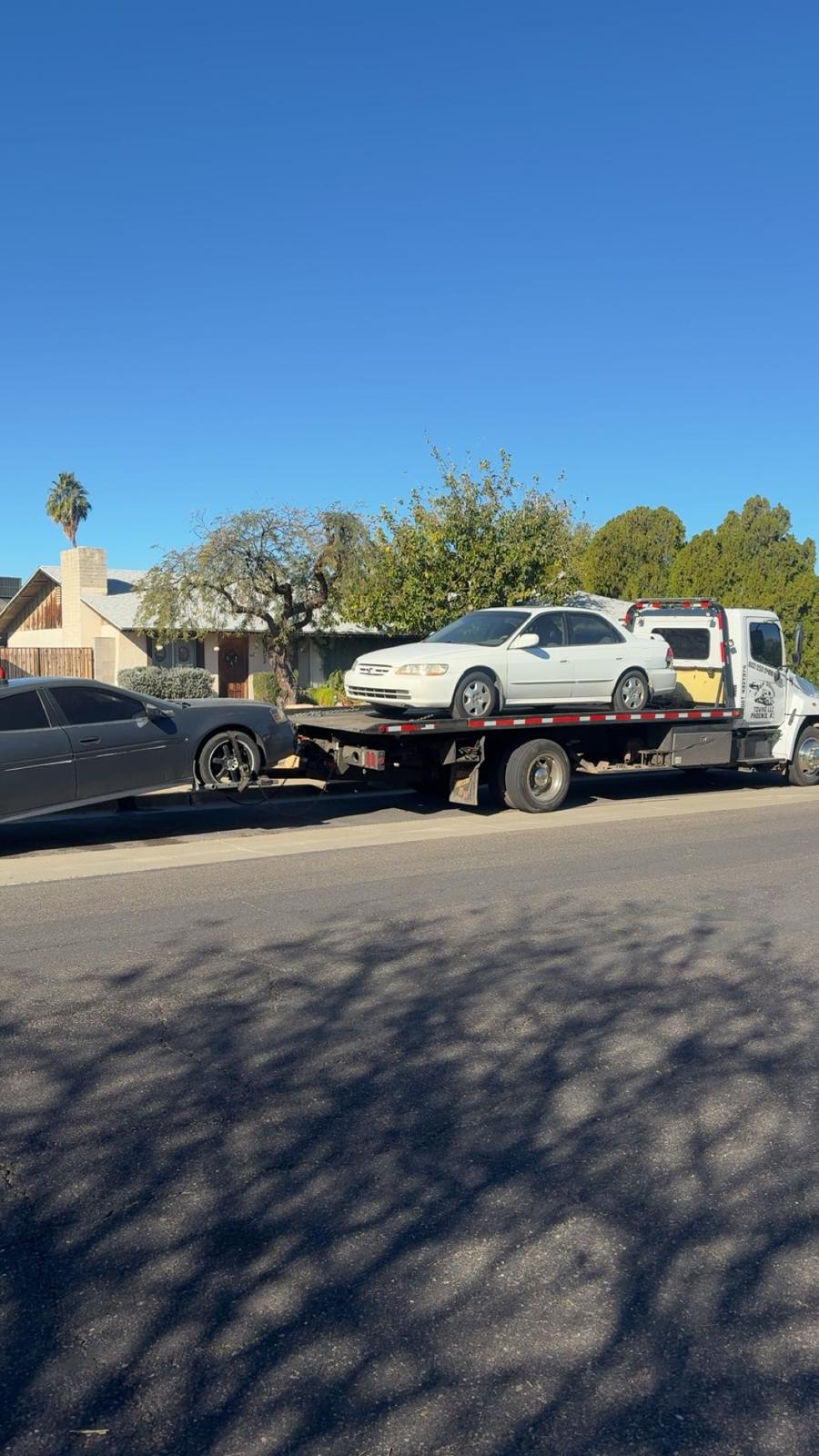 Keep Going tow truck transporting a sedan in Phoenix